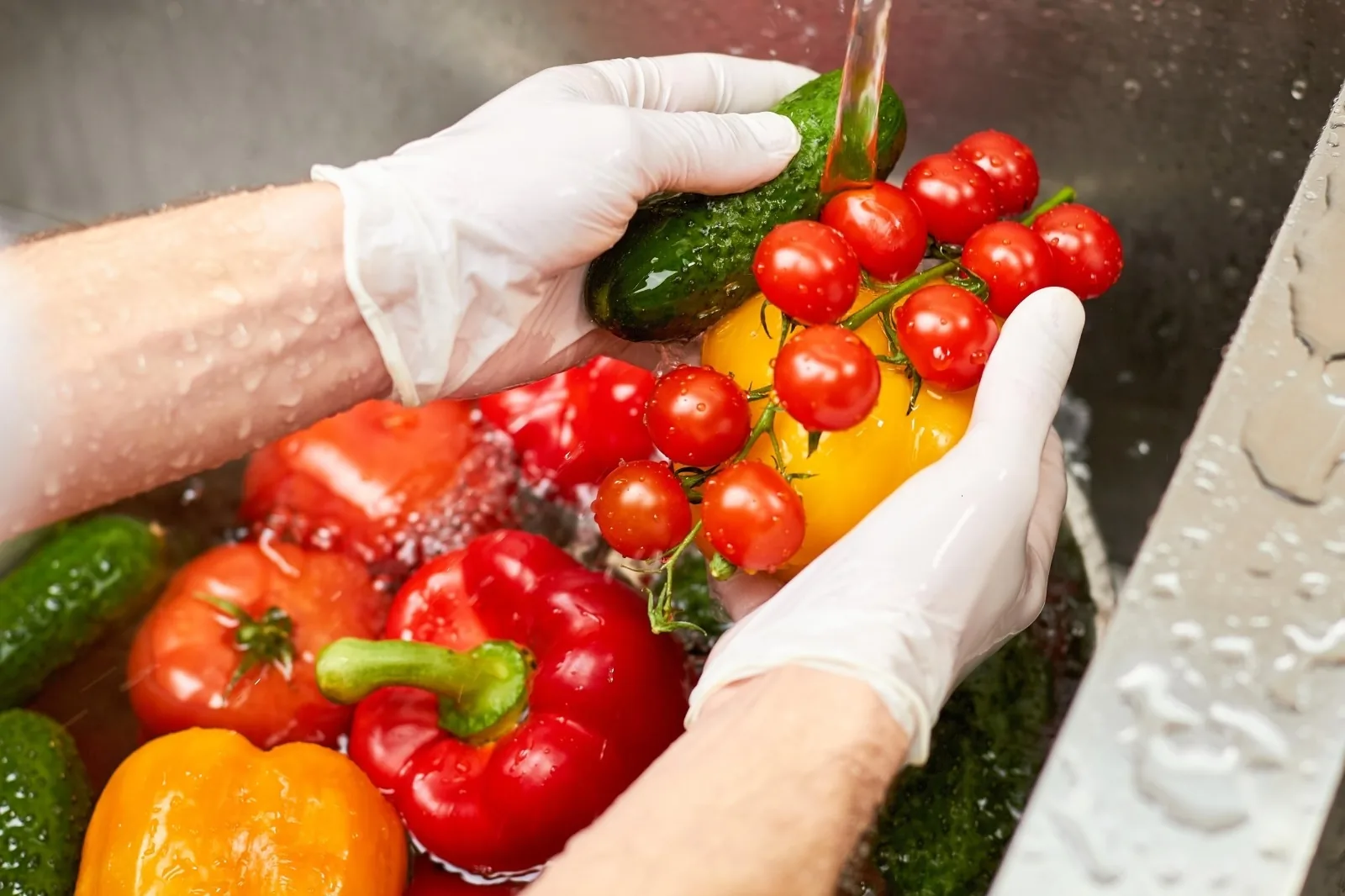 Washing fresh vegetables under running water following food hygiene practice